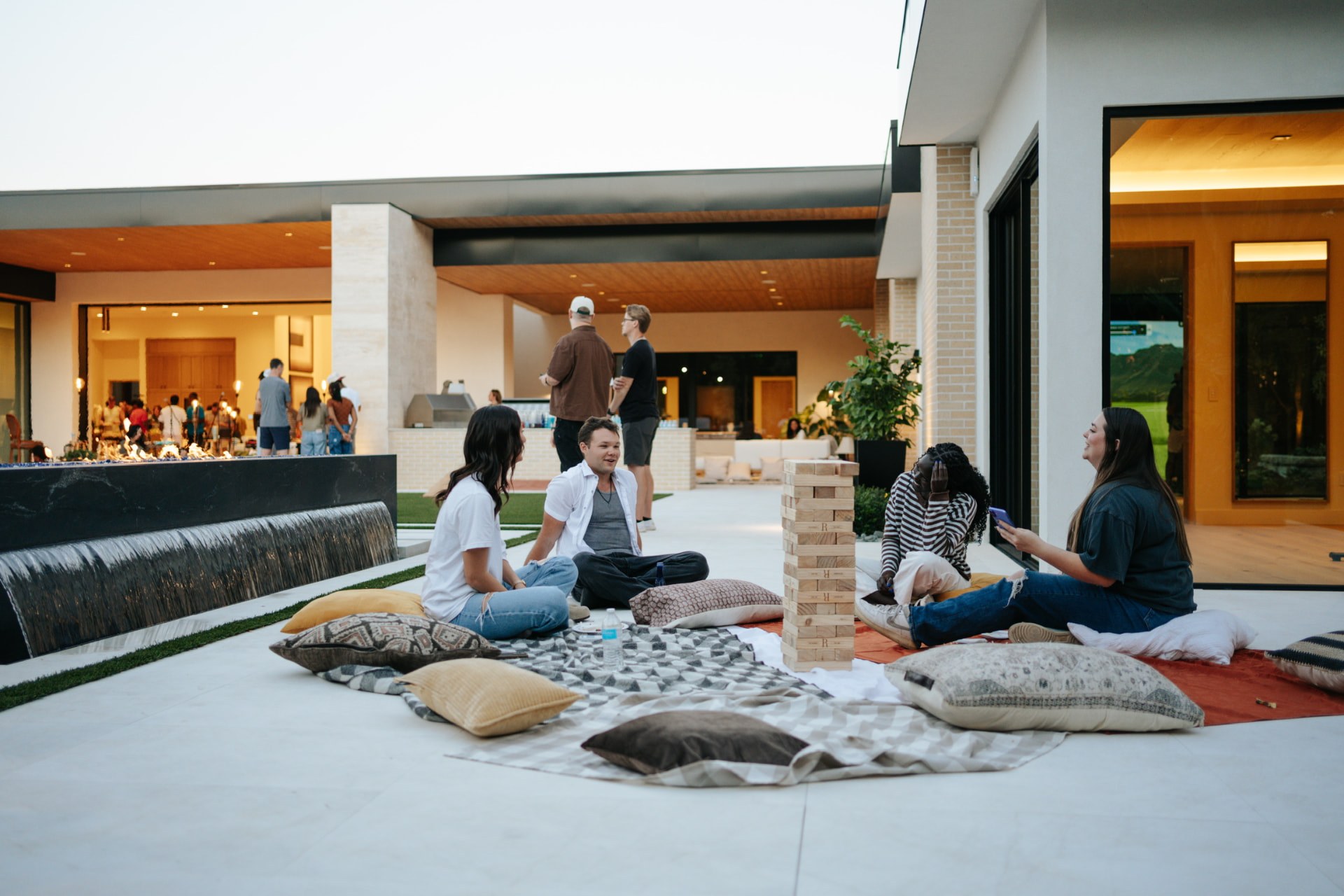 Friends connecting over lawn games at a Sunday S'mores house party